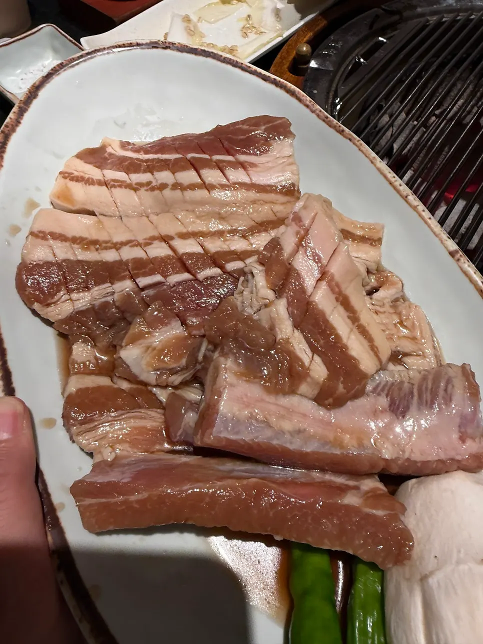 Fresh pork galbi grilling over charcoal