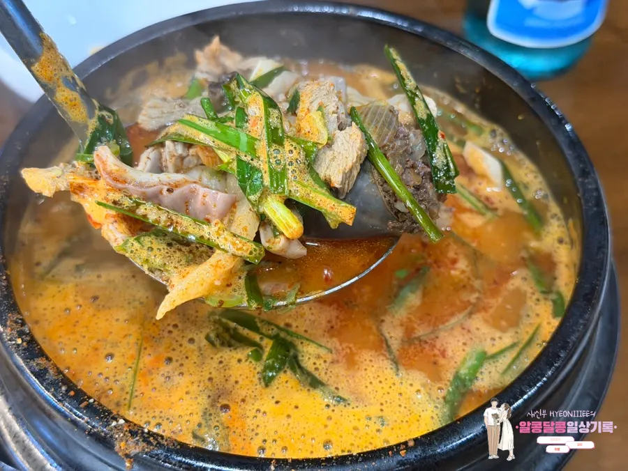 A spoonful of sulguk broth lifted up