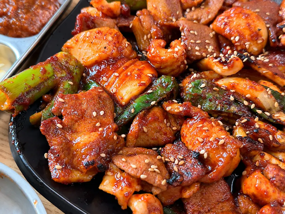 Two servings of charcoal-grilled ojam bulgogi