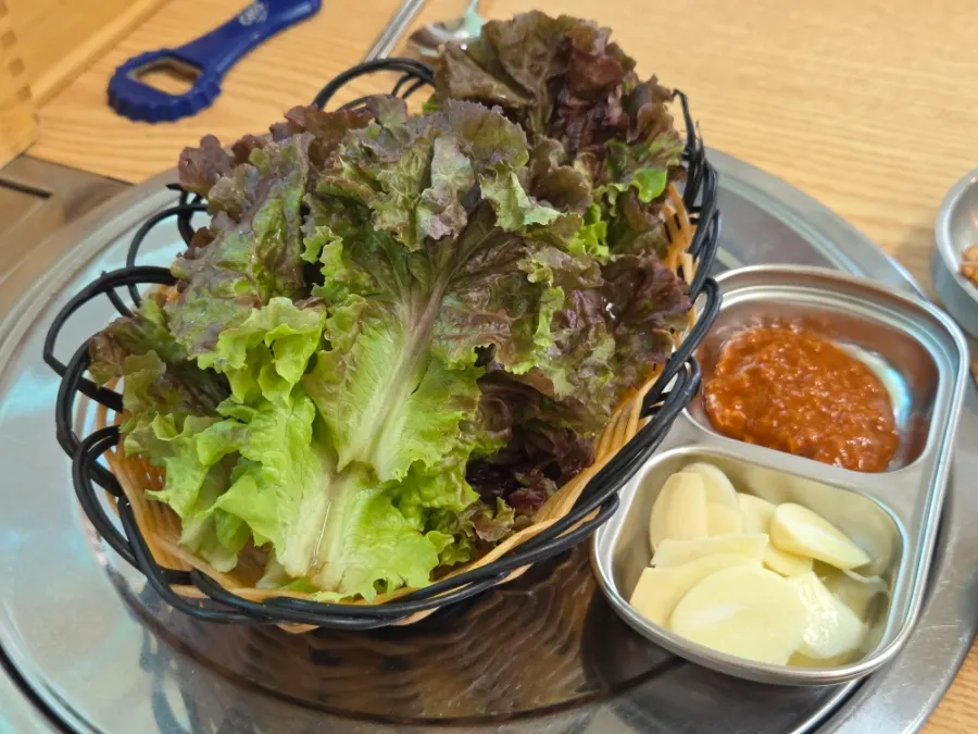 Plate of side dishes including fried burdock root, spicy radish salad, and white kimchi