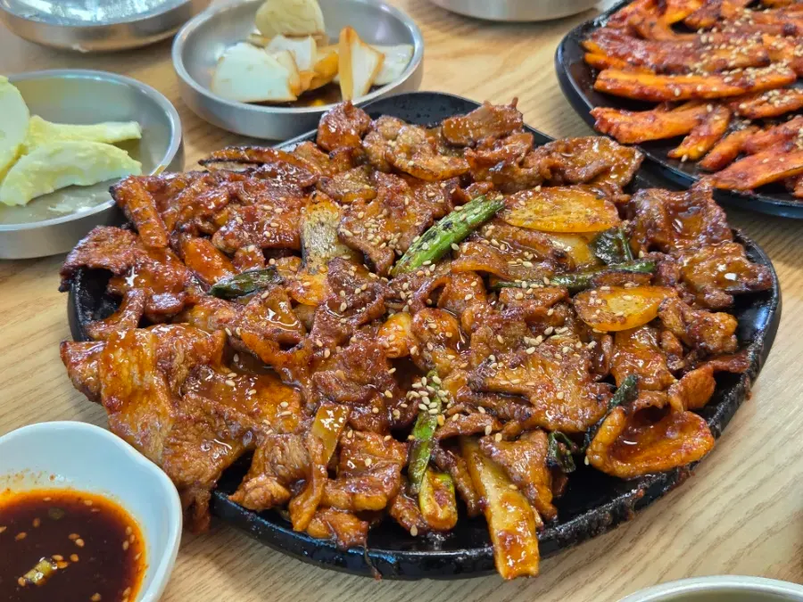 A plate piled high with charcoal-grilled black pork for two