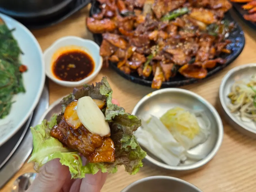 A table spread with grilled meat and buchujeon together