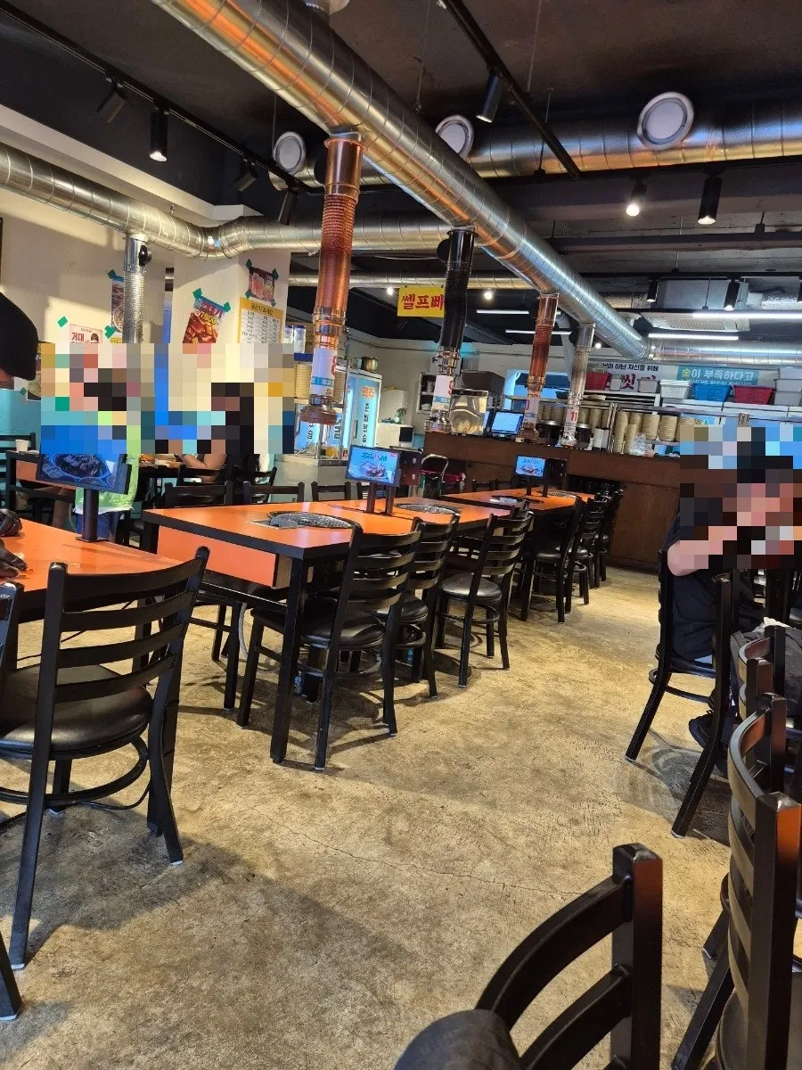 Spacious interior of Gim Geumja Sutbul Galbi Daeyeon Branch with roomy table spacing