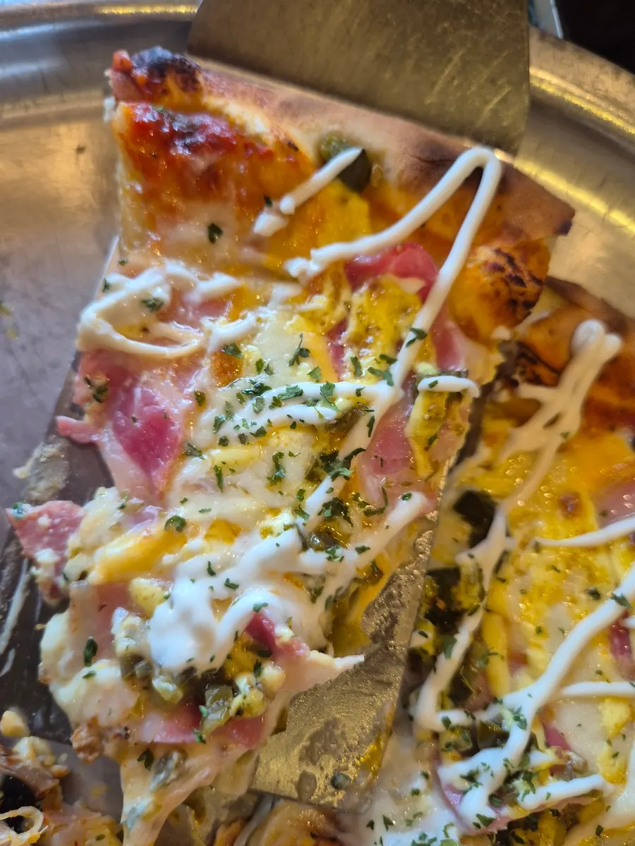 A slice of bacon potato pizza