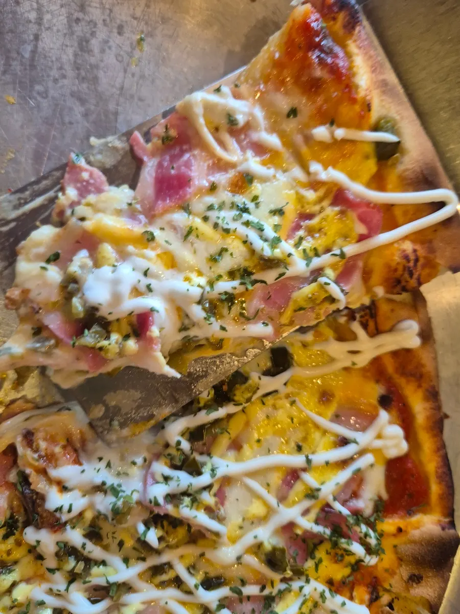 Bacon potato pizza drizzled with mayo sauce