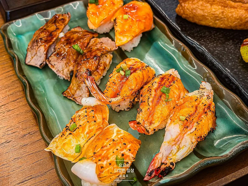 Flame-seared sushi topped with two different sauces