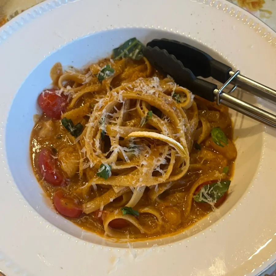 The first dish served, a plate of red shrimp bisque pasta