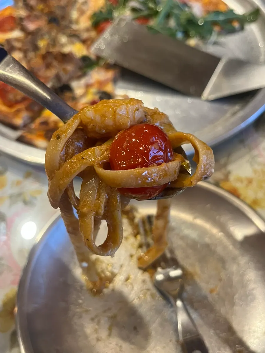 Red shrimp meat and tomato on a spoon