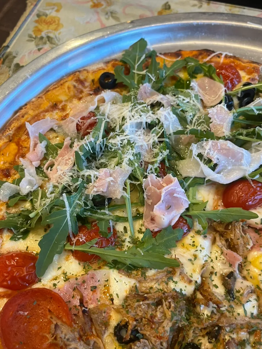 Half of the pizza with Jeju jambon arugula toppings