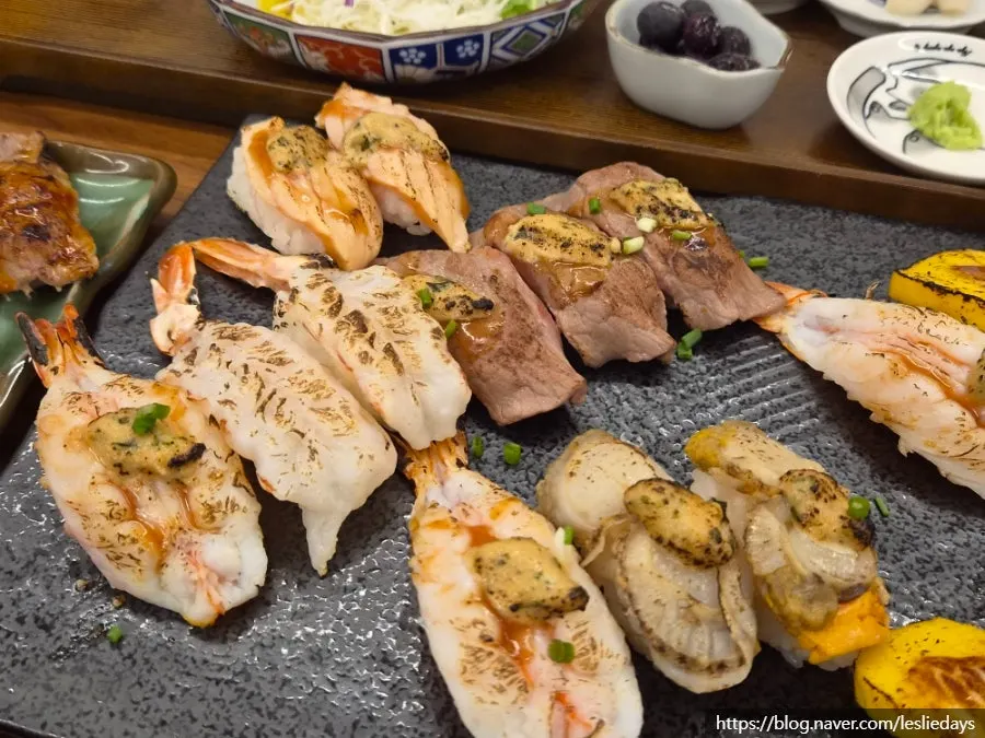 A piece of flame sushi with buttery sauce