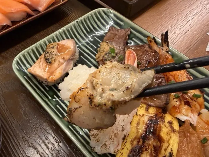 Close-up view of flame-seared sushi toppings