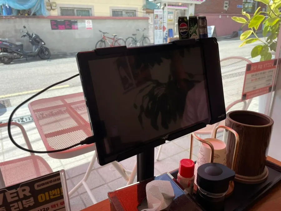 Table setup with sauce, utensil holder, and ordering tablet