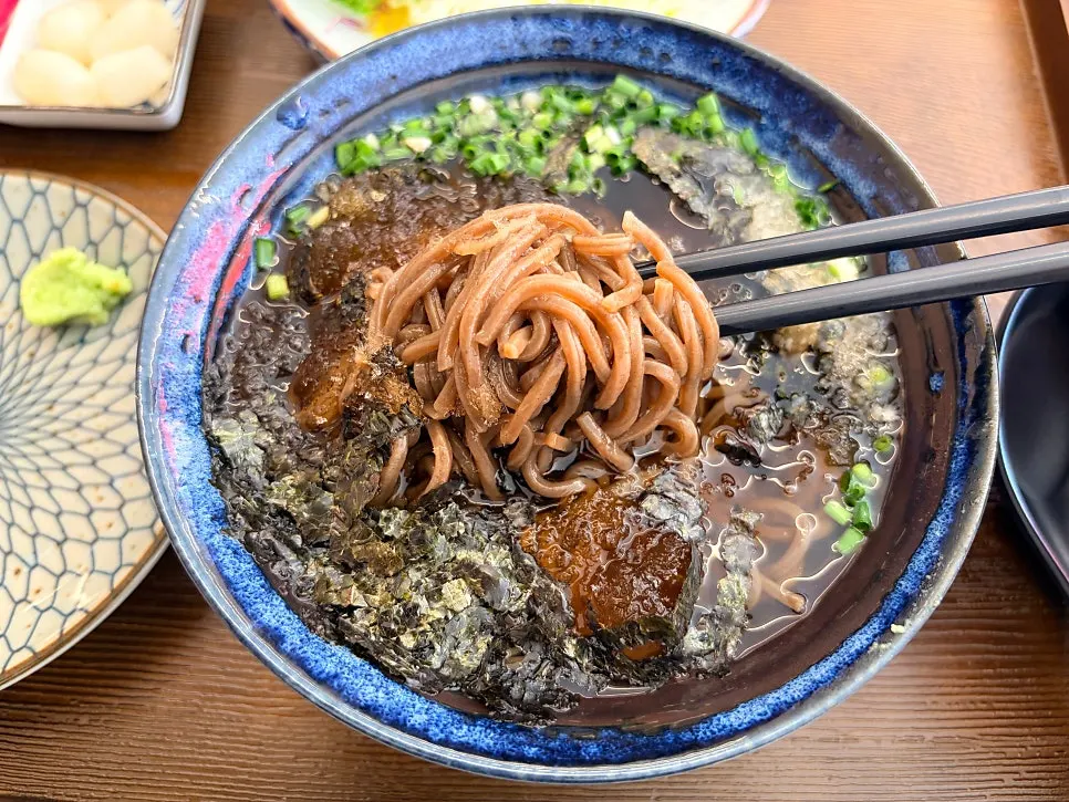 Soba served alongside sushi on the table