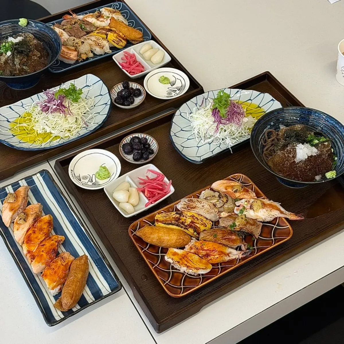 Flame-seared sushi set with half garlic, half spicy sauce laid out on the table