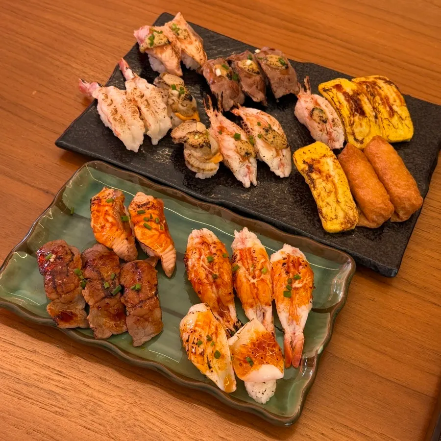 Full spread of 27 pieces of flame sushi in two bowls