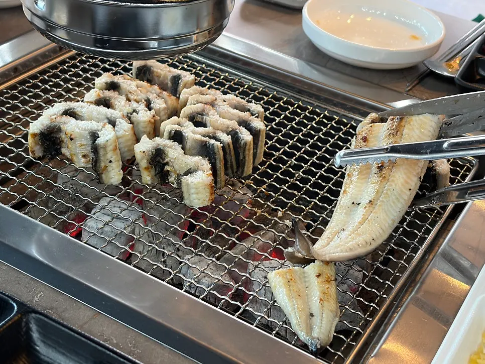 Pre-grilled freshwater eel placed on the charcoal grill