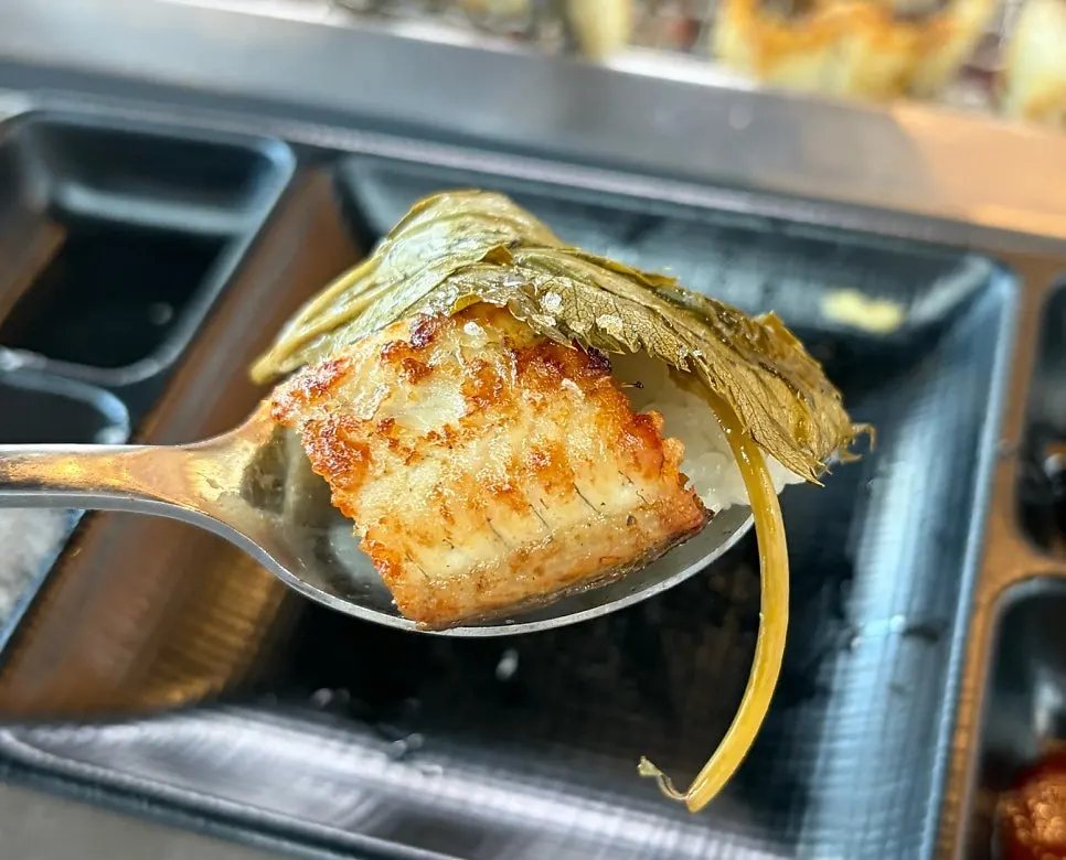 A piece of eel eaten together with side dishes