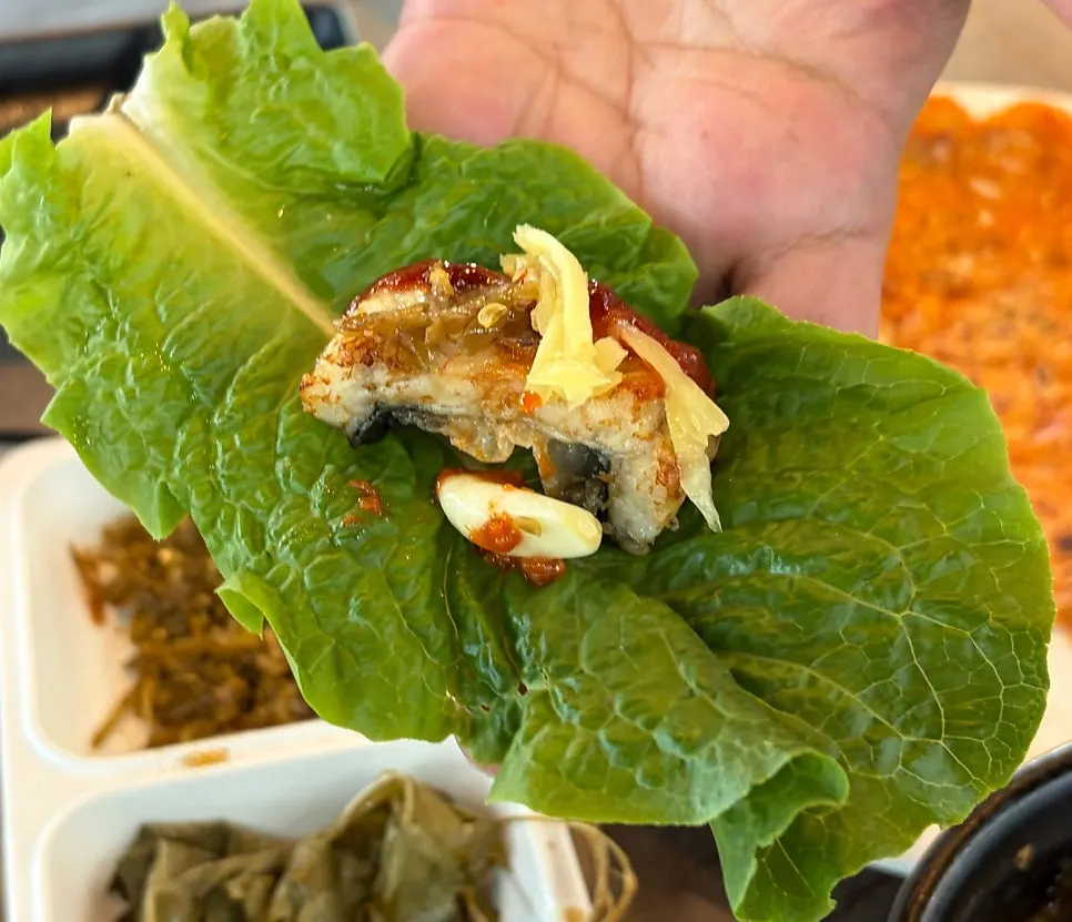 A neatly wrapped eel lettuce wrap