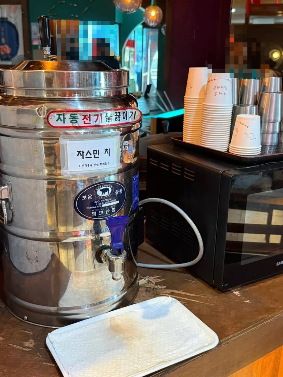 Pickled radish and jjajai laid out at Dongbaek's self-serve bar