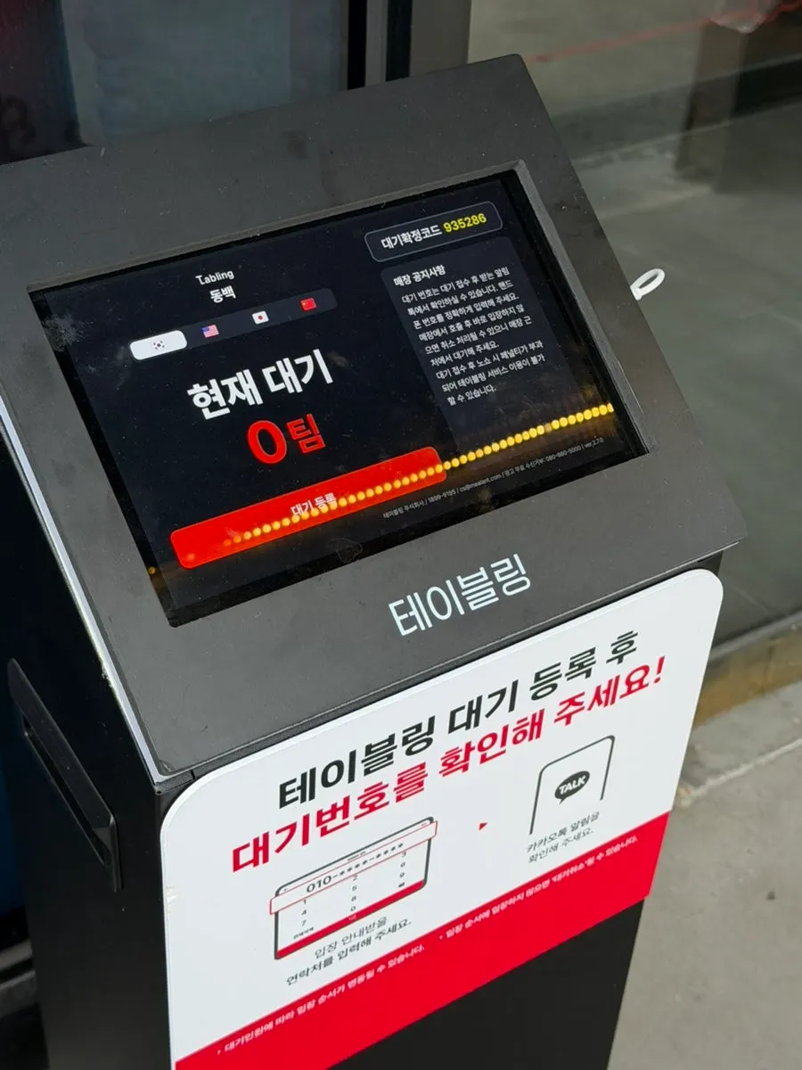 A cup of takeout coffee being handed over