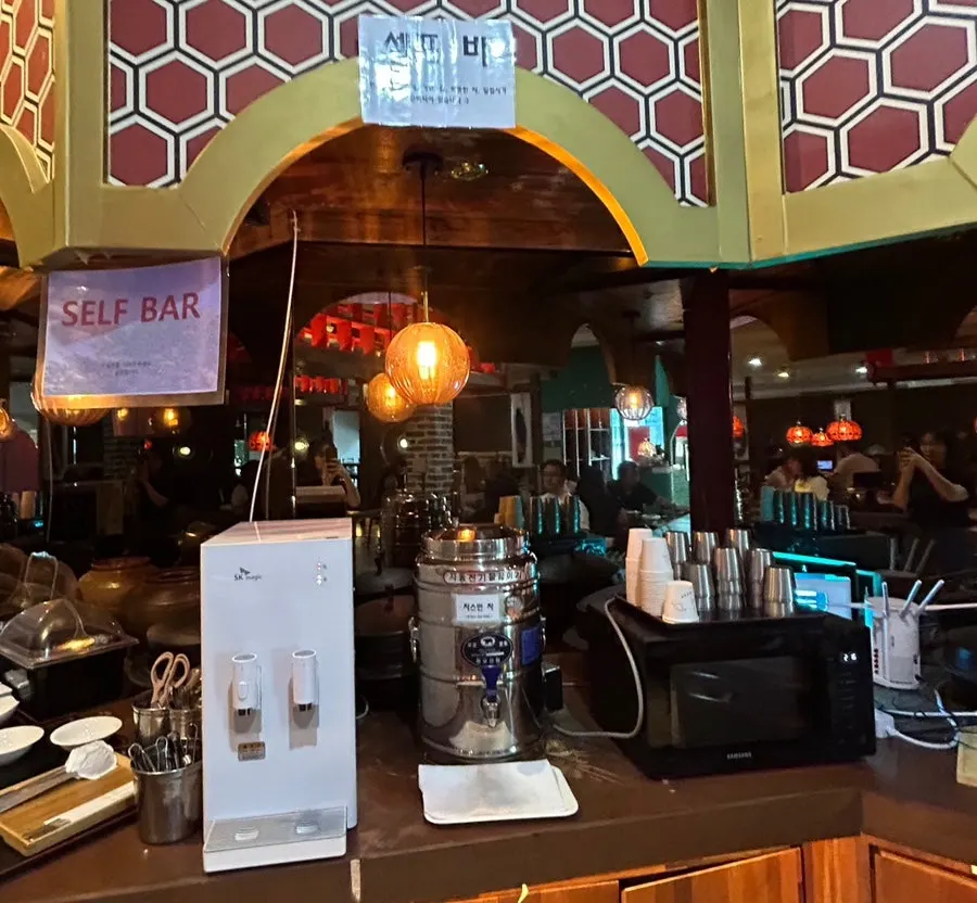 Utensils and side dishes at the self-serve bar