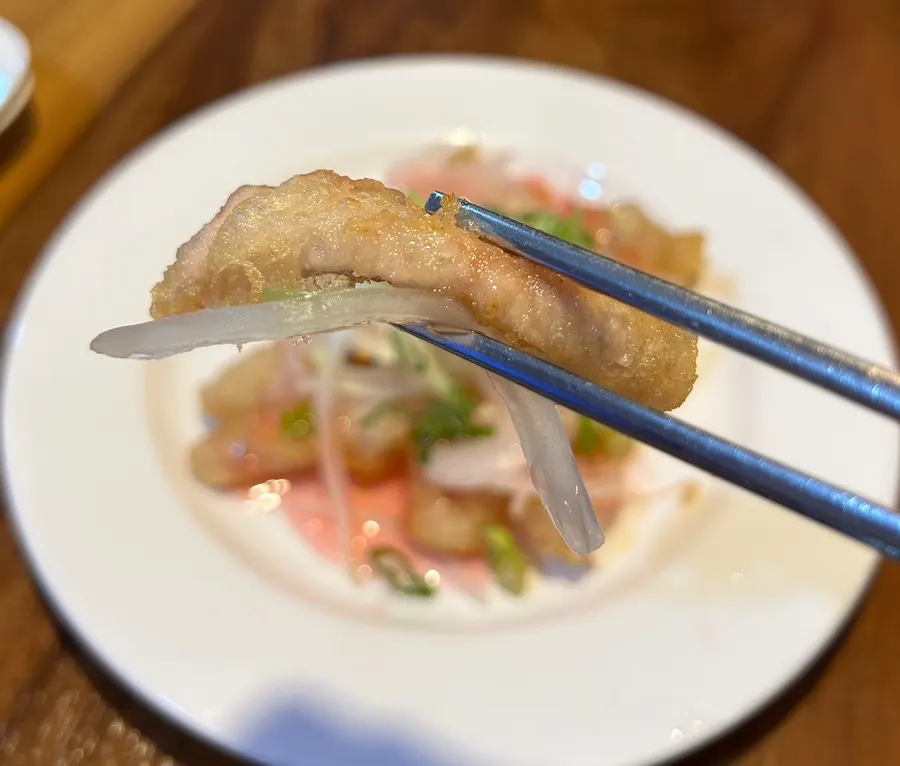 Close-up of tangsuyuk topped with shredded onion