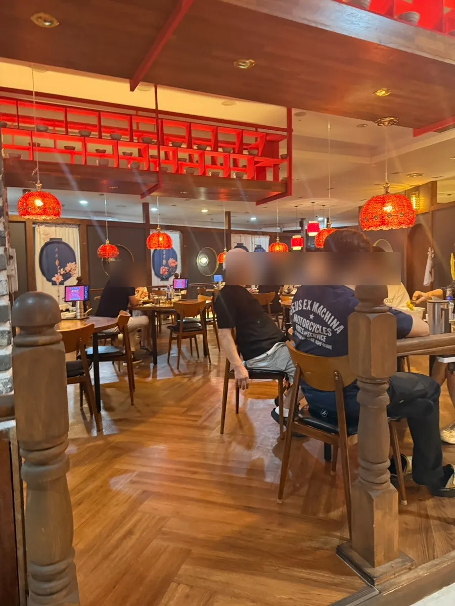 Interior of the Chinese restaurant decorated in wood and red tones