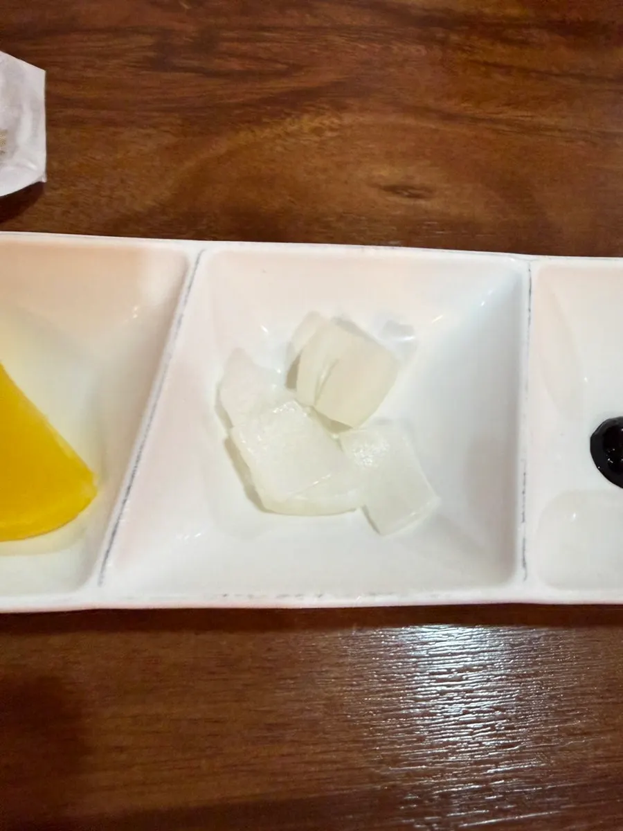 Basic side dishes of pickled radish, onion, and black bean paste