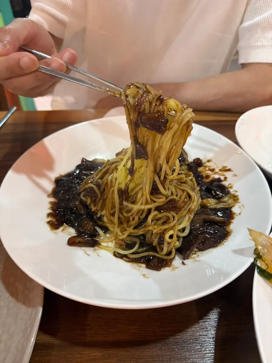 Close-up of the mixed jjajangmyeon sauce and noodles