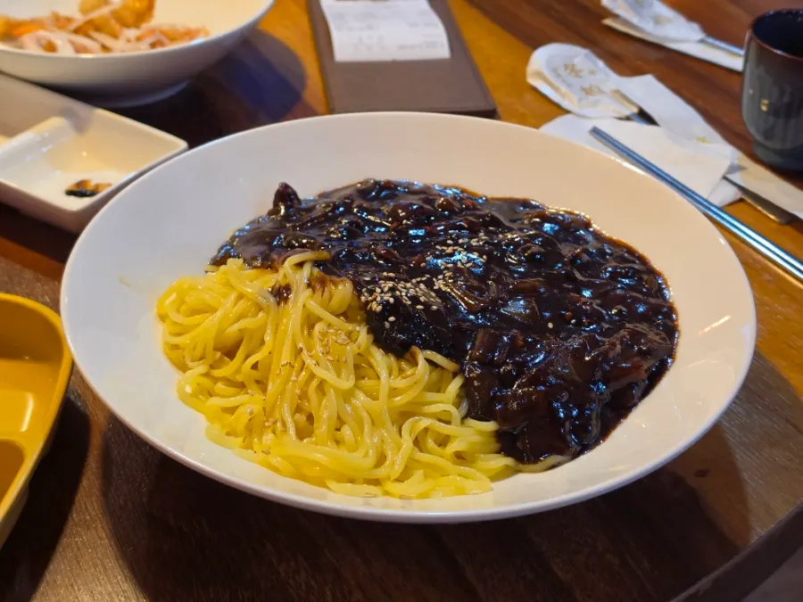 A bowl of jjajangmyeon served first