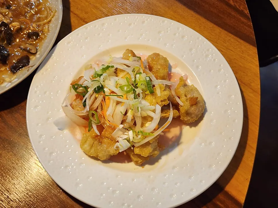 Close-up of tangsuyuk topped with pink sauce