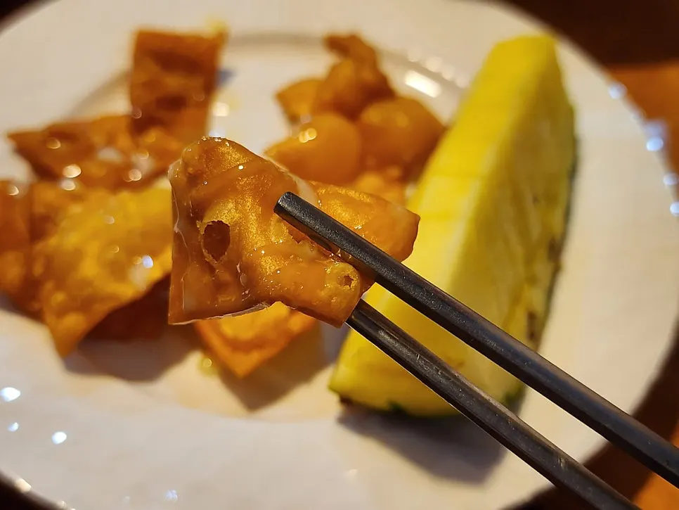 Dessert of fried bread with condensed milk and pineapple