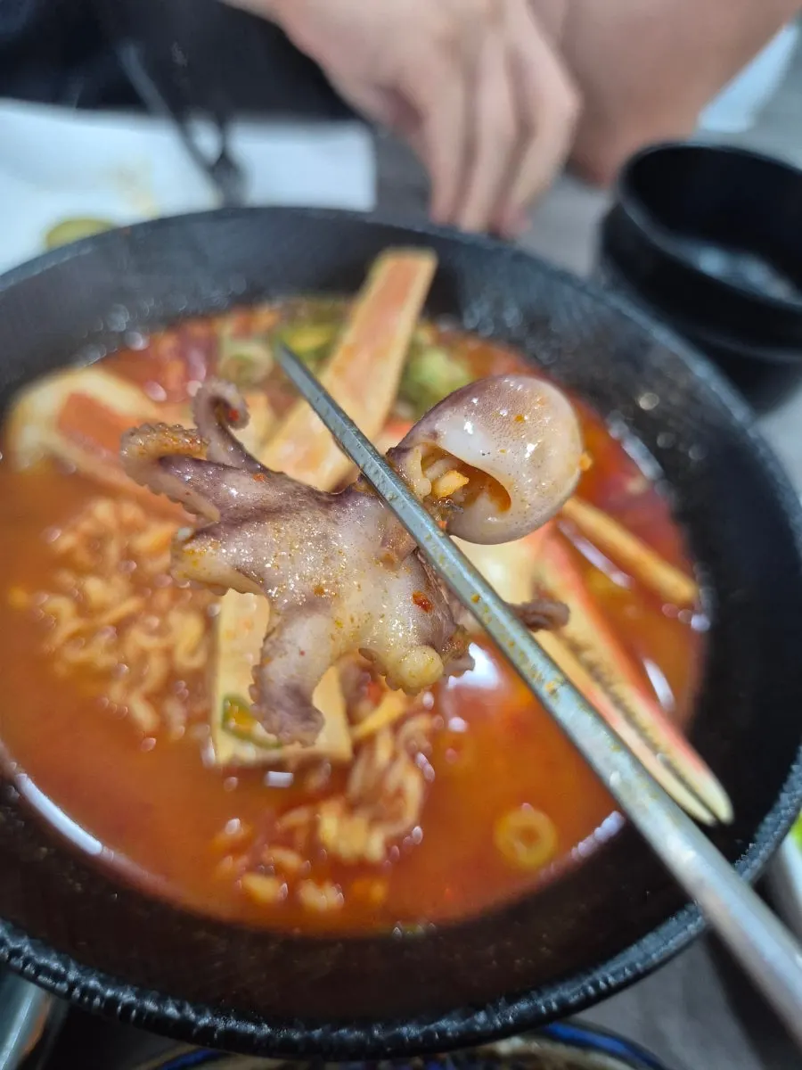 Ramyeon topped with a whole crab