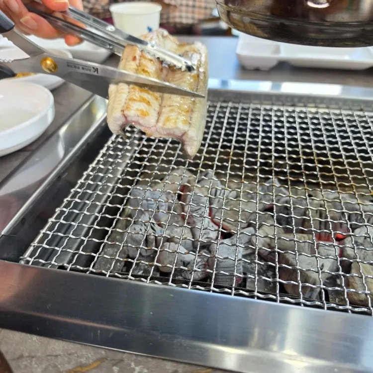 Eel turning golden on the charcoal grill