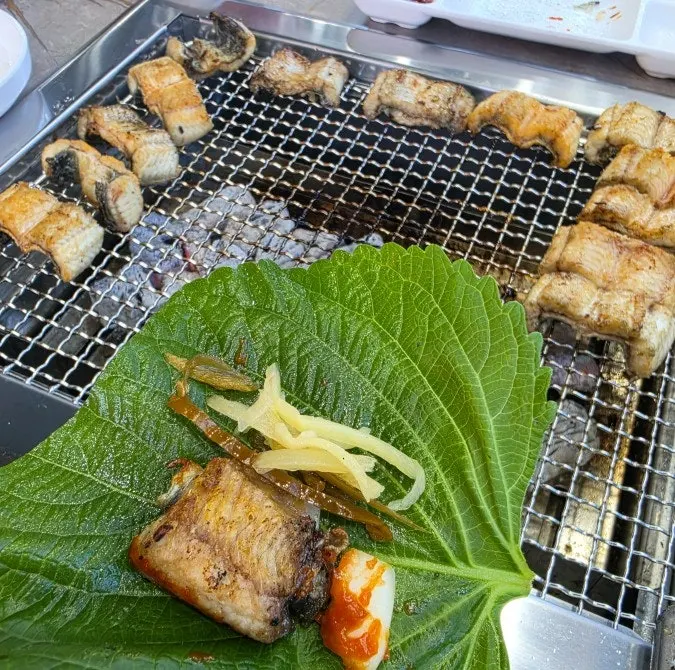 Eel wrapped with garlic and ginger in a lettuce leaf