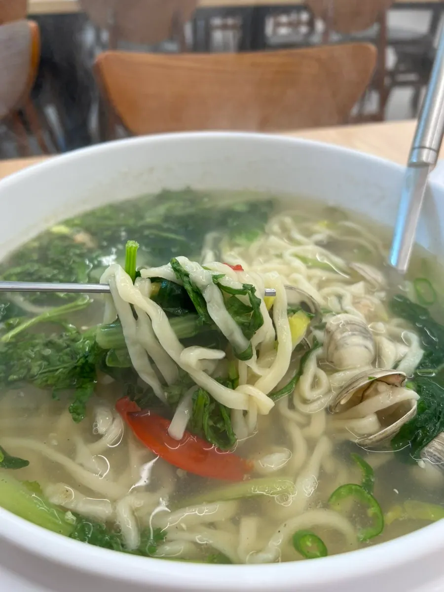 Bowl of kalguksu generously loaded with clams