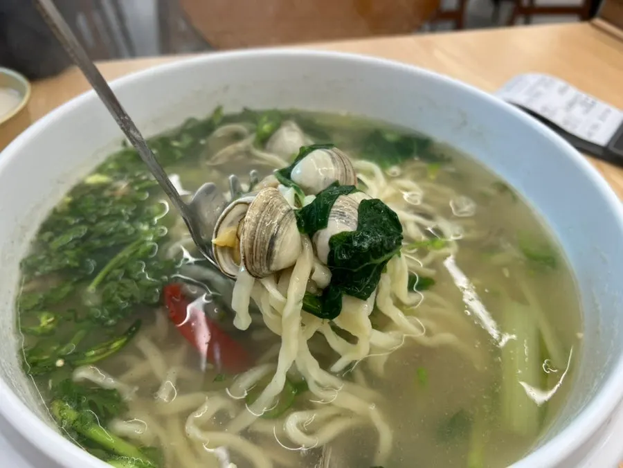 Noodles lifted up with the broth