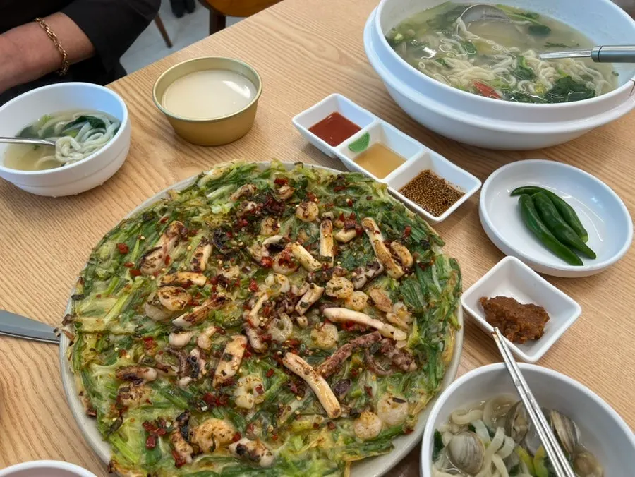 A piece of the pancake loaded with seafood