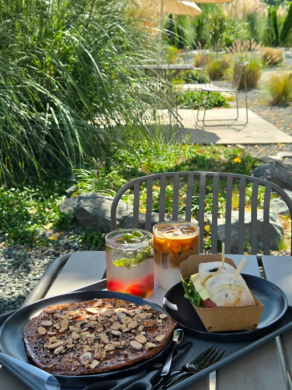 Full spread of kkeurungji, sandwich, vanilla latte, and tomato basil ade