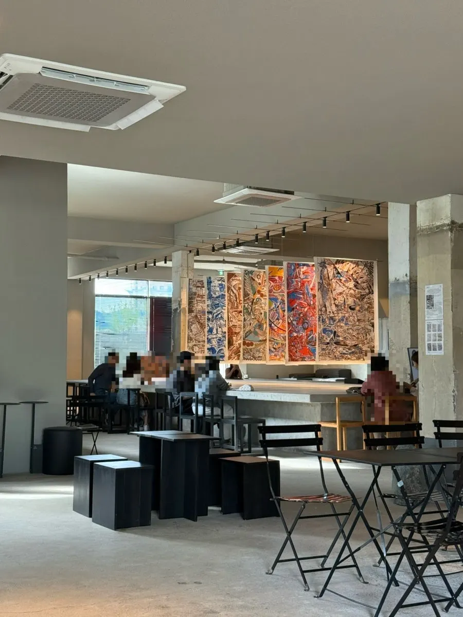 Square communal table for viewing the exhibition from different angles