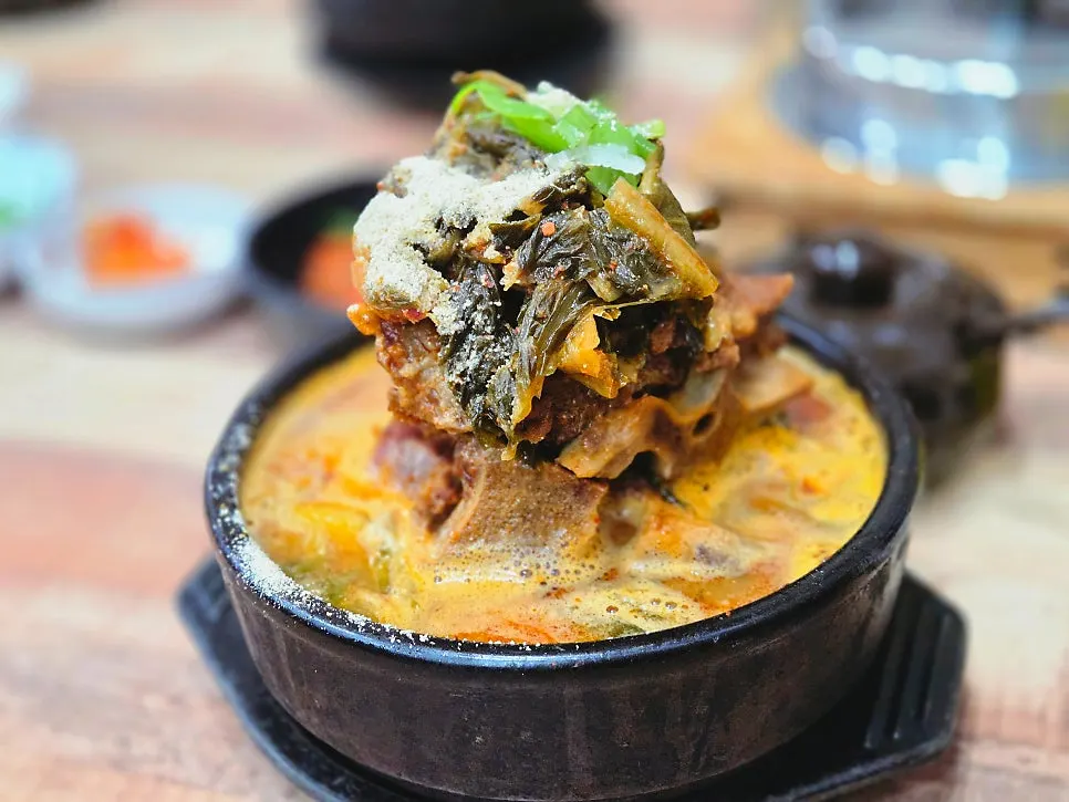 Ppyeo-haejangguk served bubbling in a stone bowl