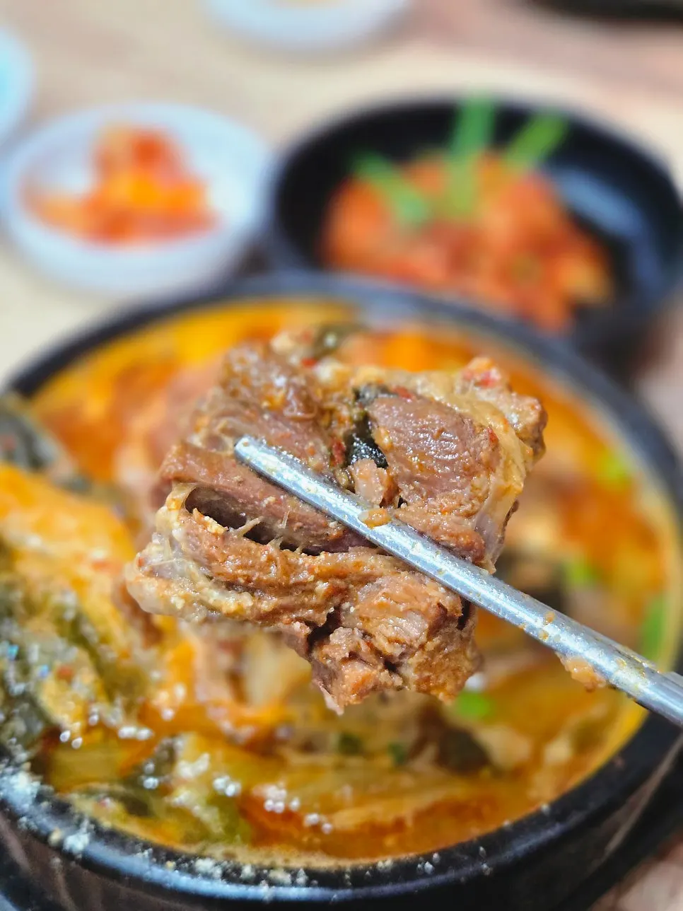 Eating gamjatang meat by hand