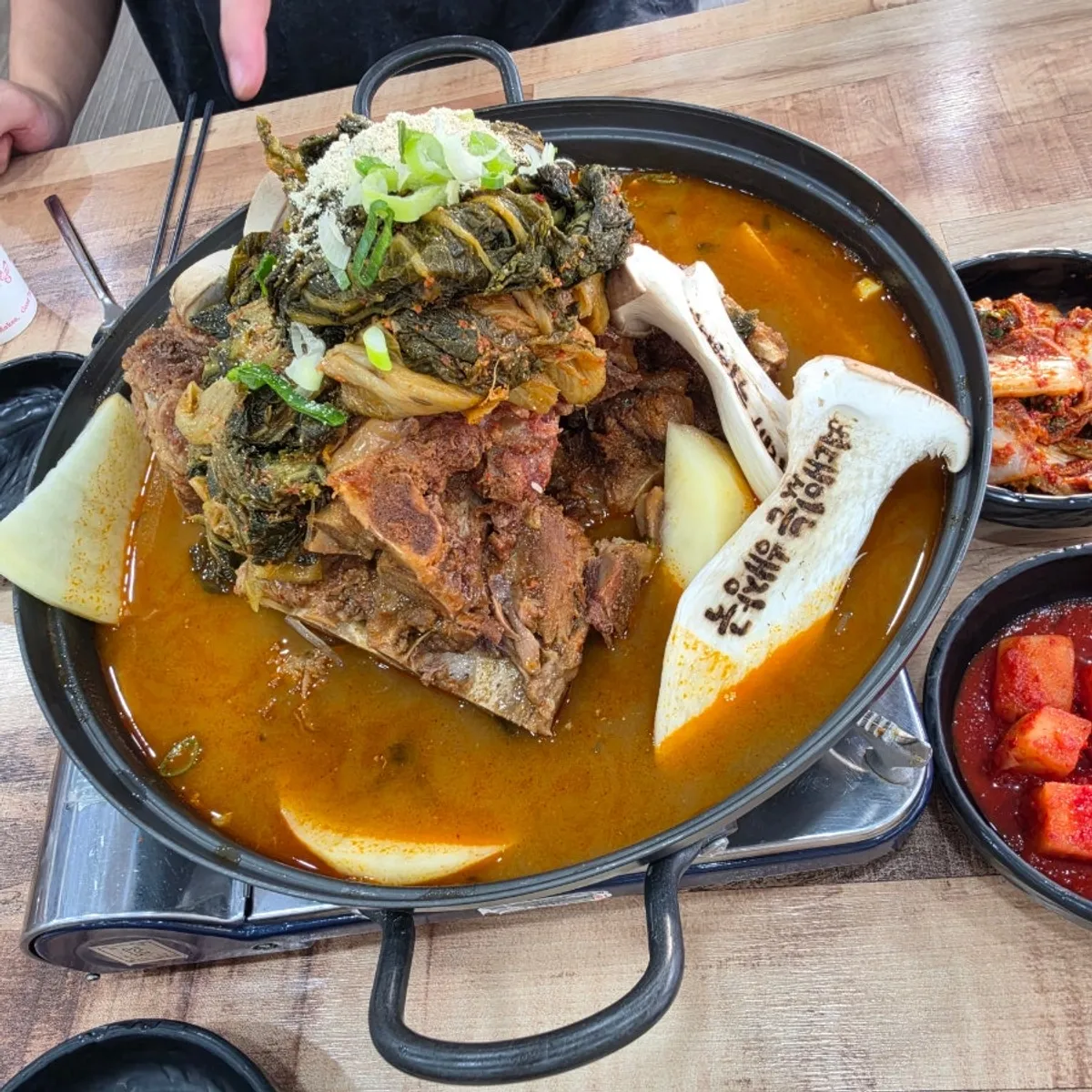 Side dish spread including boiled pork slices and kimchi