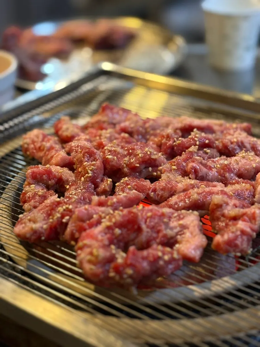 Flipping the marinated beef short rib while grilling