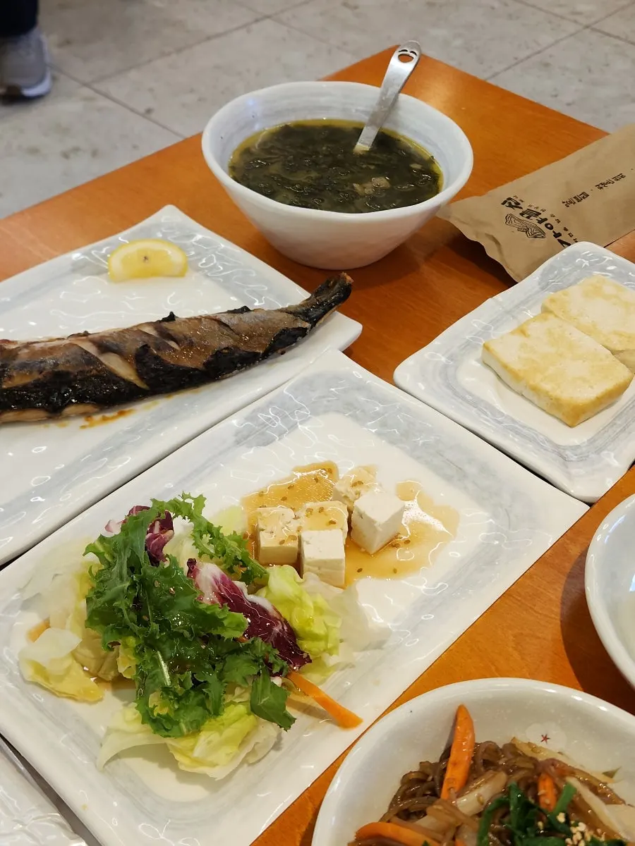 Seasoned raw crab, japchae and other banchan