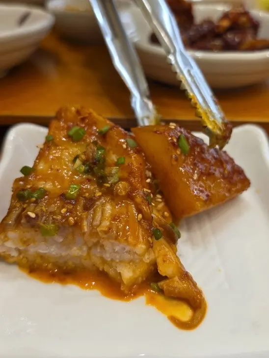 Picking up a piece of the braised skate