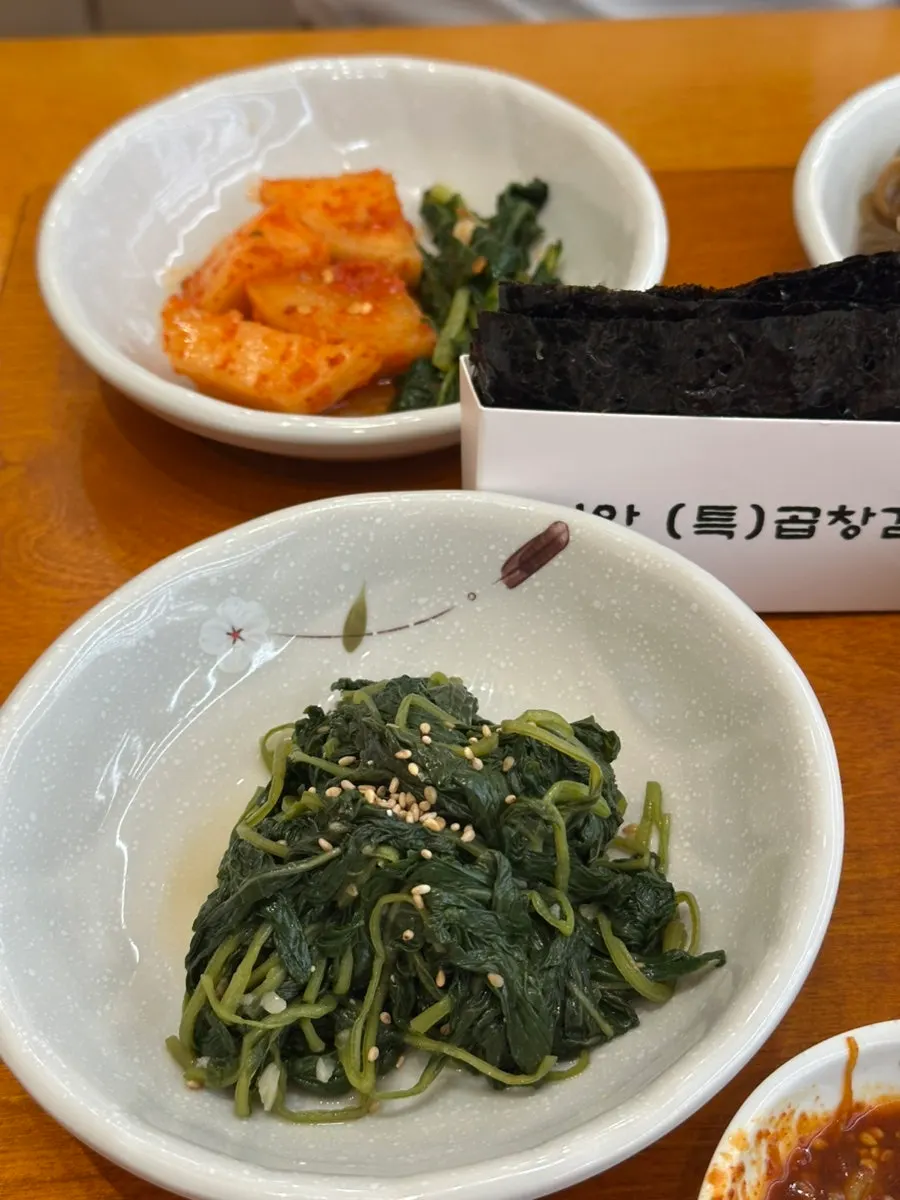 Tofu and stir-fried kimchi side dishes at Gaya Kkeutjip