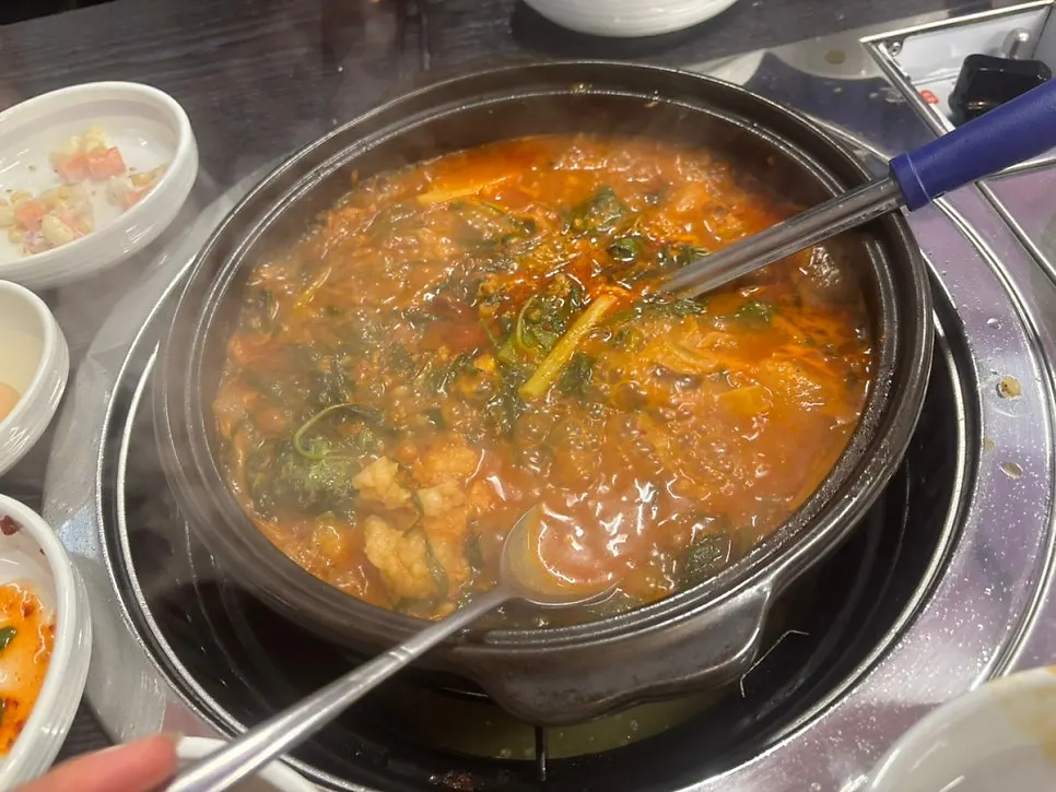 The gopchang hot pot broth reduced and deepened in color