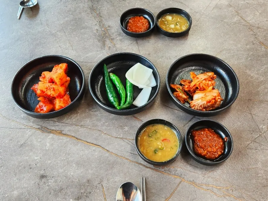 Side dishes of cubed radish kimchi and kimchi