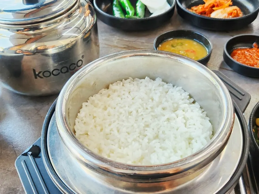 Freshly cooked pot rice and bone stew table setting